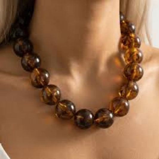 Chunky tortoise bead necklace with glossy amber and dark brown round acrylic beads.