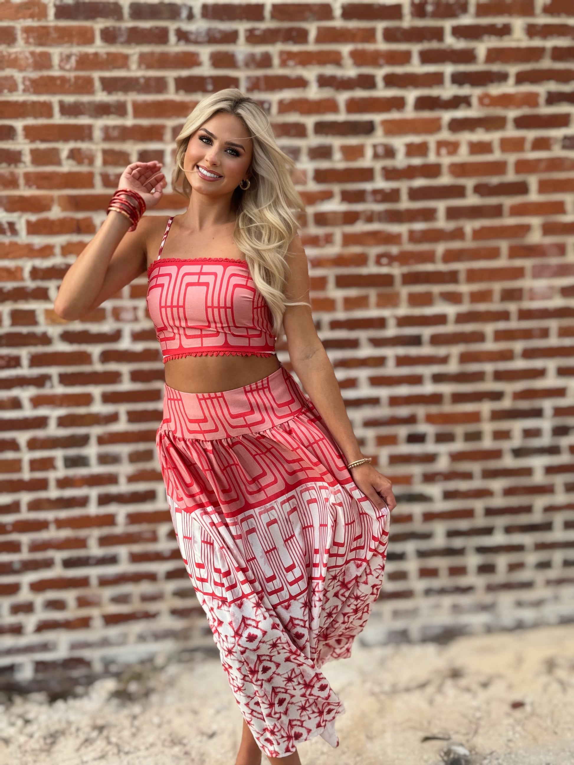Woman wearing the Retro Red and white geometric crop top and coordinating midi skirt set with white sneakers