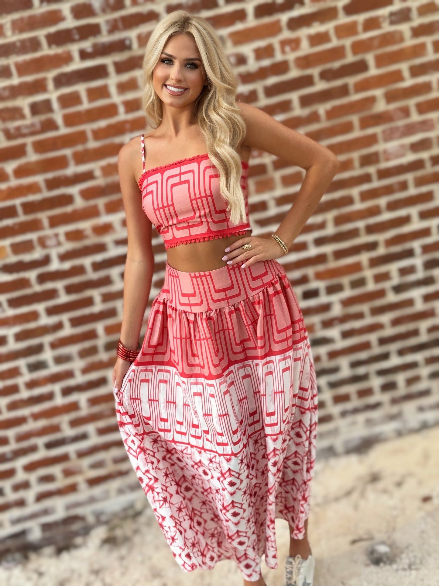 Woman wearing the Retro Red and white geometric crop top and coordinating midi skirt set with white sneakers