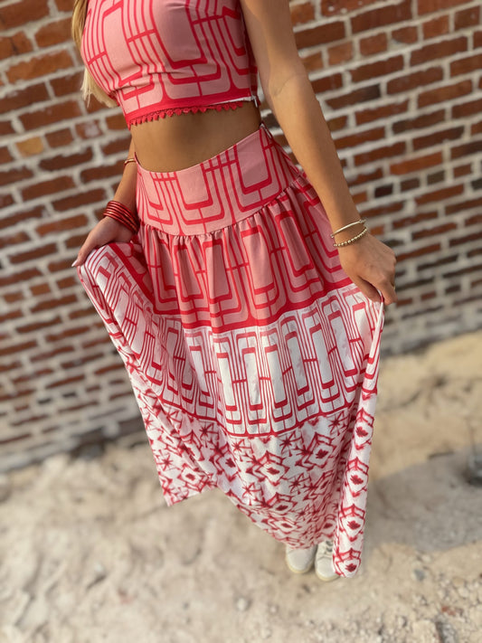 Woman wearing the Retro Red and white geometric crop top and coordinating midi skirt set with white sneakers