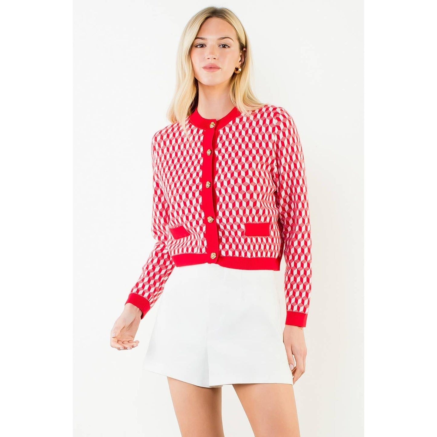 Woman wearing a red and white checkered cardigan with a white background
