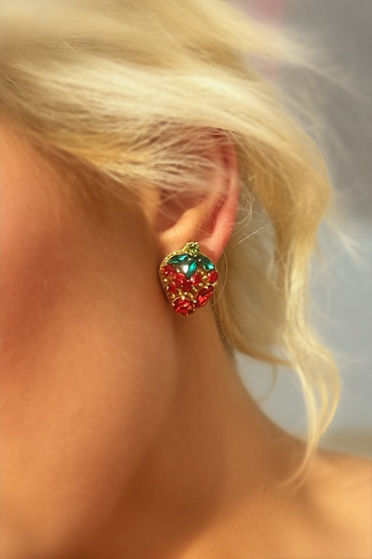 Red and green rhinestone strawberry statement earrings with crystal leaf accents and gold-tone trim displayed on jewelry cards.