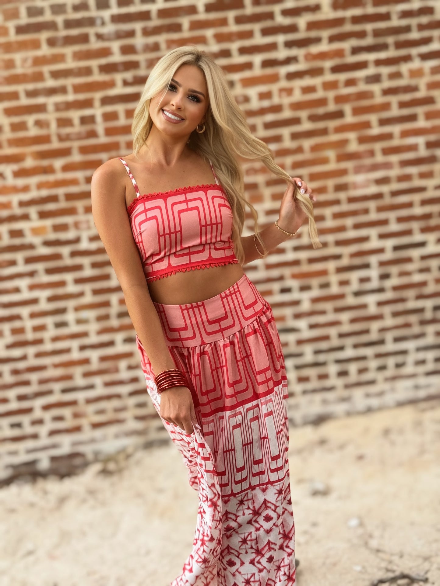 Woman wearing the Retro Red and white geometric crop top and coordinating midi skirt set with white sneakers