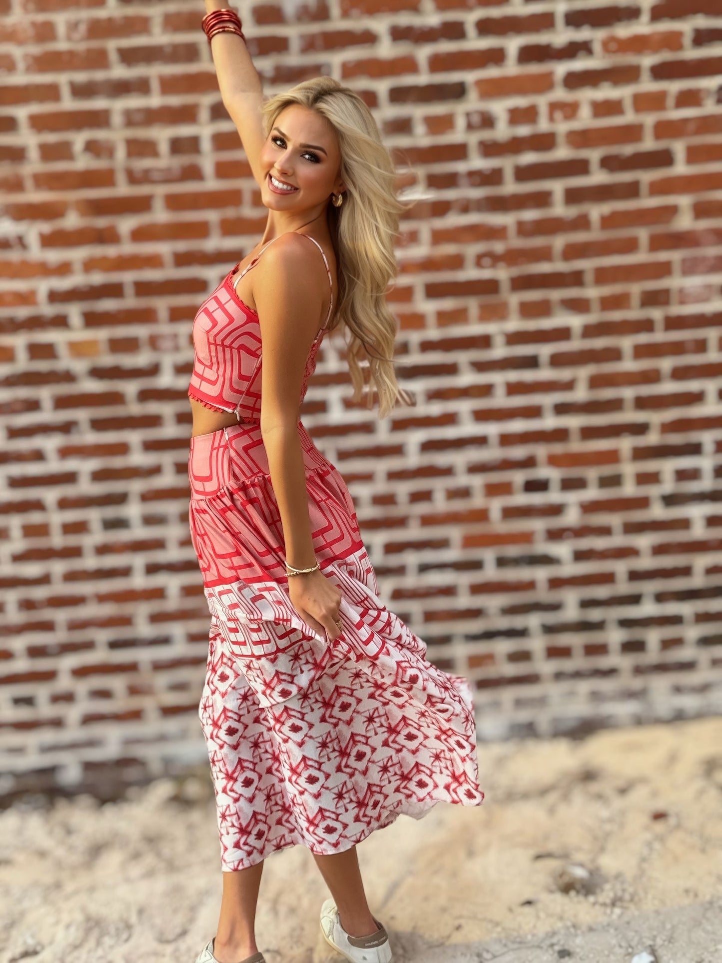 Woman wearing the Retro Red and white geometric crop top and coordinating midi skirt set with white sneakers
