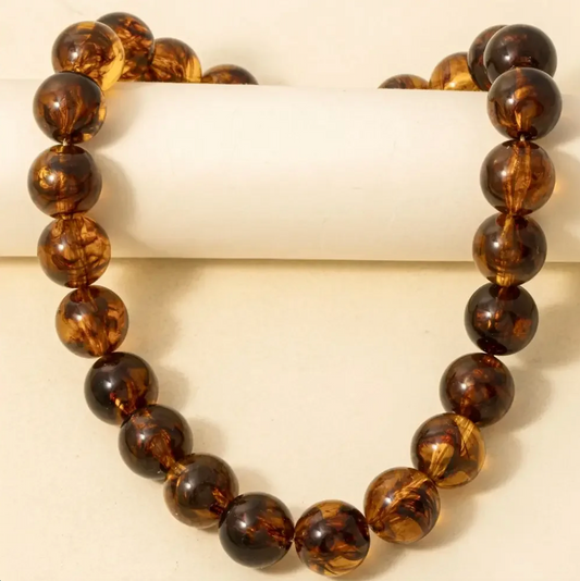  Chunky tortoise bead necklace with glossy amber and dark brown round acrylic beads.

