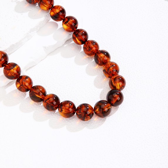  Chunky tortoise bead necklace with glossy amber and dark brown round acrylic beads.