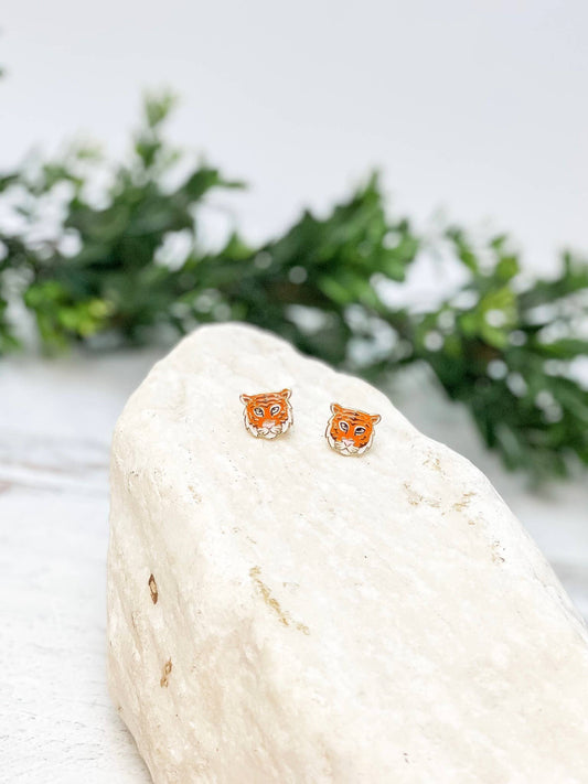 Petite orange, black and white tiger face enamel stud earrings with polished gold-tone outlines.