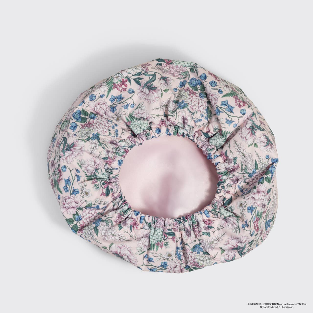 Floral-patterned shower cap on a light gray background
