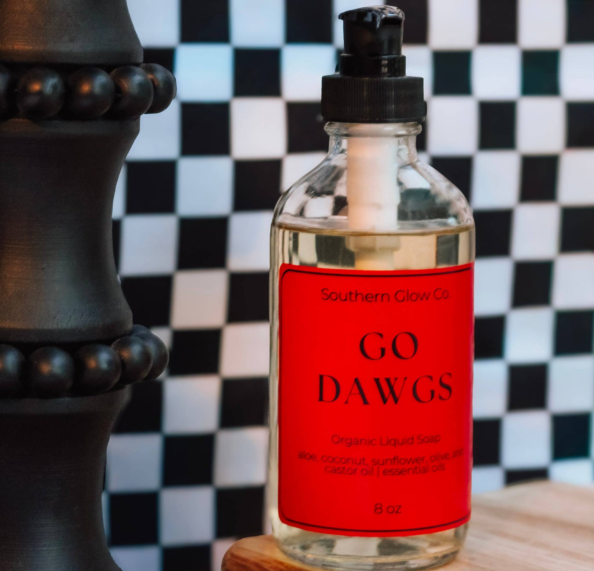 Go Dawgs organic liquid hand soap in an 8-ounce pump bottle with a red label and black-and-white checkered background.