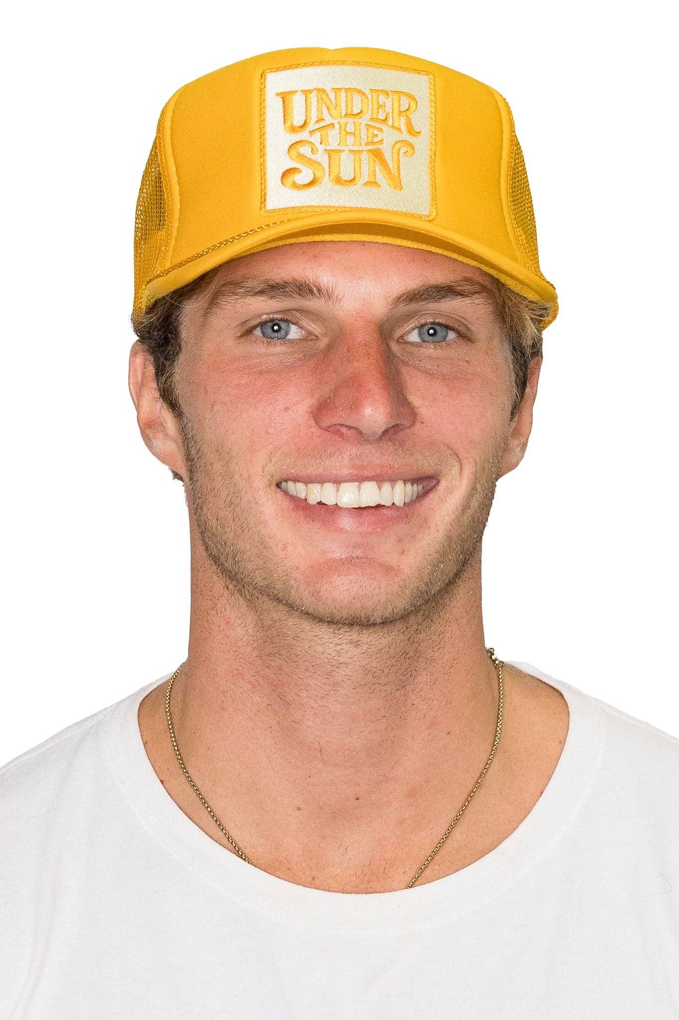 Bright yellow retro trucker hat featuring an embroidered "Under The Sun" patch with breathable mesh back and adjustable snapback design.