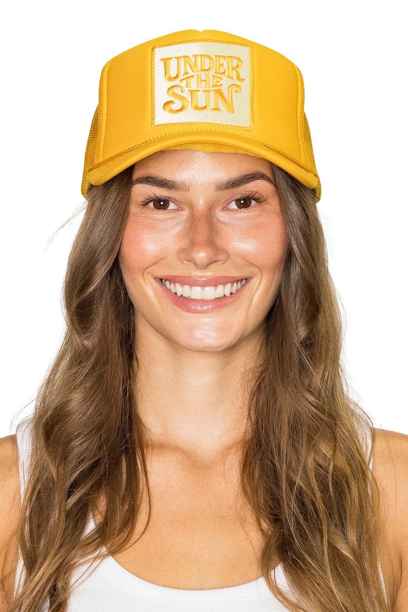 Bright yellow retro trucker hat featuring an embroidered "Under The Sun" patch with breathable mesh back and adjustable snapback design.